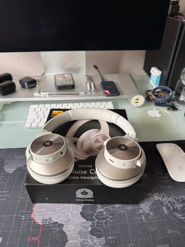 Silver Oneodio headphones on a desk
